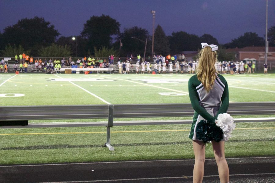 Maddy Sims stands at attention during a pause in the Homecoming game.